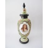 A probably French white opaline vase with cover, with printed panel of a portrait and over gilded
