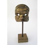 A modern bronze sculpture of a mask H33cm.