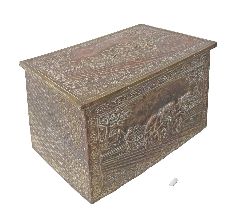 An English wooden box for fire wood, lined on the outside with repousse brass, opening to reveal one