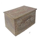 An English wooden box for fire wood, lined on the outside with repousse brass, opening to reveal one