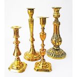 A collection of European brass candlesticks c19th century. H23-32cm (4)