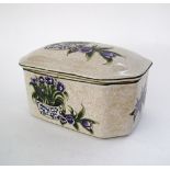 A large ceramic box and cover, probably French, decorated with purple tulips, W22cm. (2)
