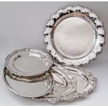 A collection of five silver plated serving dishes with gadrooned rims. W25cm - W35cm - L32cm, L40cm,