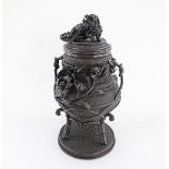 A Chinese / Japanese bronze incense burner / urn with cover, with a lion finial on the cover, flower