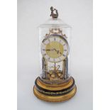 A late 20th century Hettich Quartz West German Anniversary clock with brass dial and pendulum,