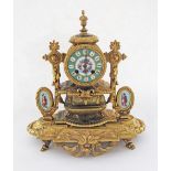 A French Louis XVI style gilt bronze, porcelain mounted mantle clock, the dial face with coloured