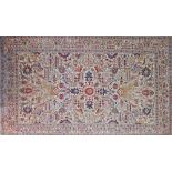 A Persian carpet with all over geometric motifs on beige background. 225X316cm. The carpet is worn