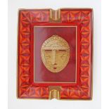 An Hermes rectangular porcelain ashtray in orange colours and gold trimmings, 20X16,5cm.