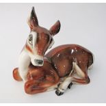 Italian porcelain of a recumbent deer. H20cm, W25cm. Chip on the ear.