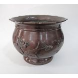 A Chinese cast bronze lobed jardinière decorated with birds on flowering branches and sea