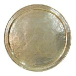 An Islamic large round brass tray engraved with Arabic calligraphy and Arabesque motifs c1900.