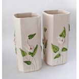 A pair of large ceramic square vases with lilies on a white ground, one with damage, H40cm. (2)