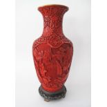 A Large Chinese red on red cinnabar carved lacquer on brass vase, decorated with scholars and