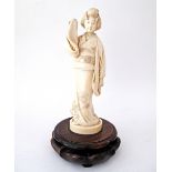 A very fine quality Japanese carved ivory figurine (Okimono) in the form of a Geisha in