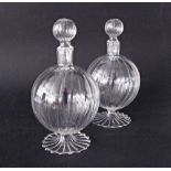 A pair of clear glass globular reeded bottles with stoppers H20cm. (4)