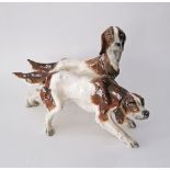 An Italian ceramic group of two hound dogs. L38cm. Damages.