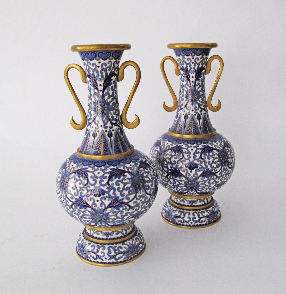 A pair of Chinese cloisonné bottle vases with flared rim and handles, decorated in blue and white,