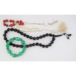 A collection of three worry-beads and a jade bead bangle. (4)