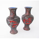 A pair of Chinese black on red carved lacquer cinnabar vases