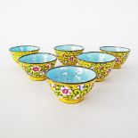 A Chinese Canton set of six brass and enamel, yellow ground tea cups
