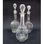 Three clear glass decanters with stoppers