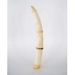 A Tribal African ivory tusk carved with animals and trees