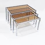 A set of three chrome plated and glass nest of side tables