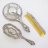 An unmarked silver mounted brush, comb and mirror