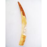 A Tribal African ivory tusk carved with a head