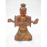 An Asian coloured and gilt wood carving of a four handed deity