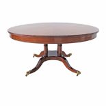 Regency style, carved and figured mahogany veneered round center table