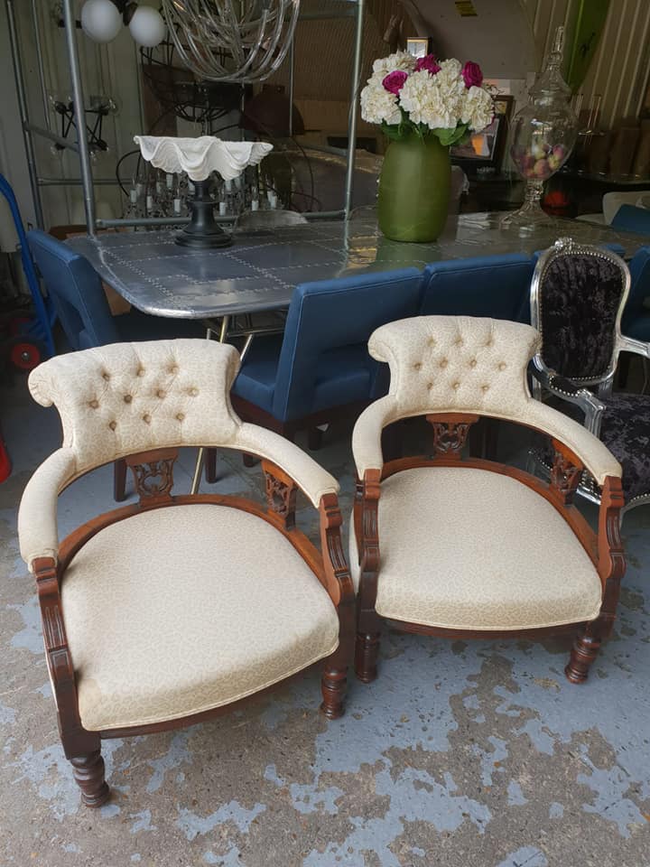 A pair of Victoria Oak carved low open armchairs tufted back rest upholstered in original mottled fa