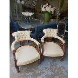 A pair of Victoria Oak carved low open armchairs tufted back rest upholstered in original mottled fa