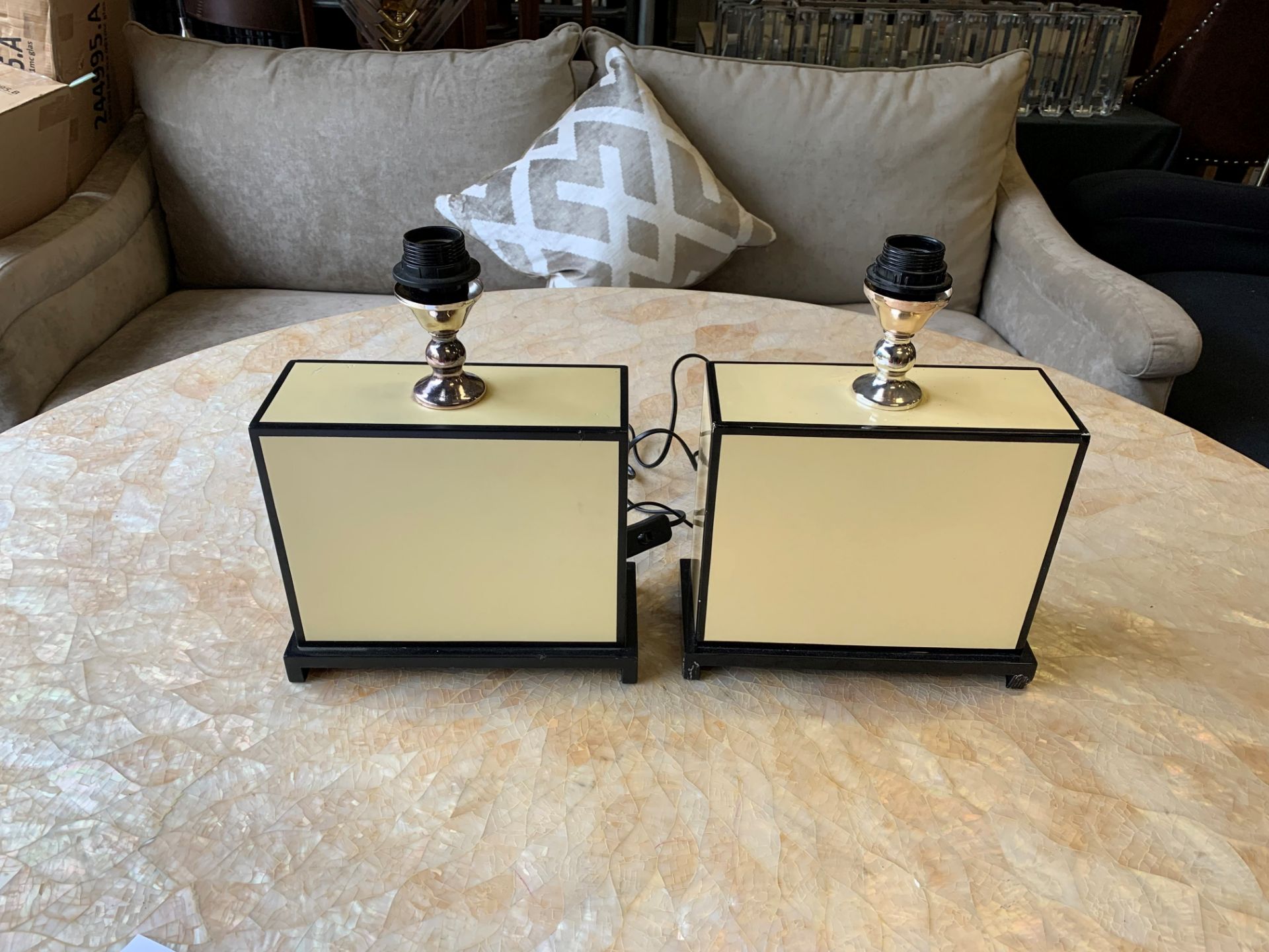 A pair of Eichholtz table lamps square laminated yellow and black on plinth ( shades not supplied)