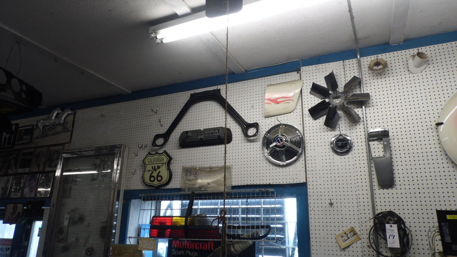 ITEMS ON WALL COBRA VALVE COVER, SPINNER HUB CAP, ETC.