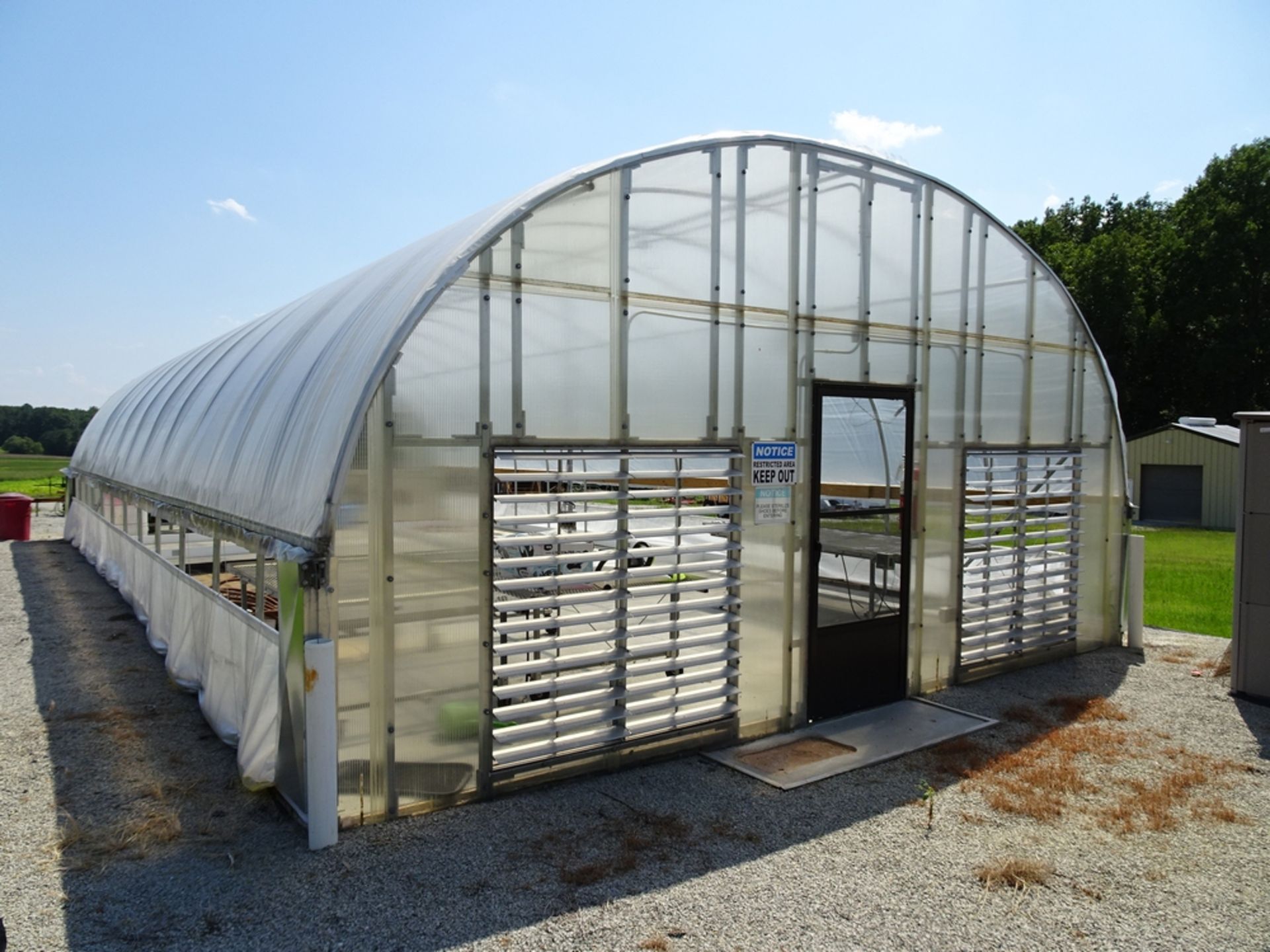 approximately 22 foot by 48 foot arch style 3 season Greenhouse with corrugated and Walls 2