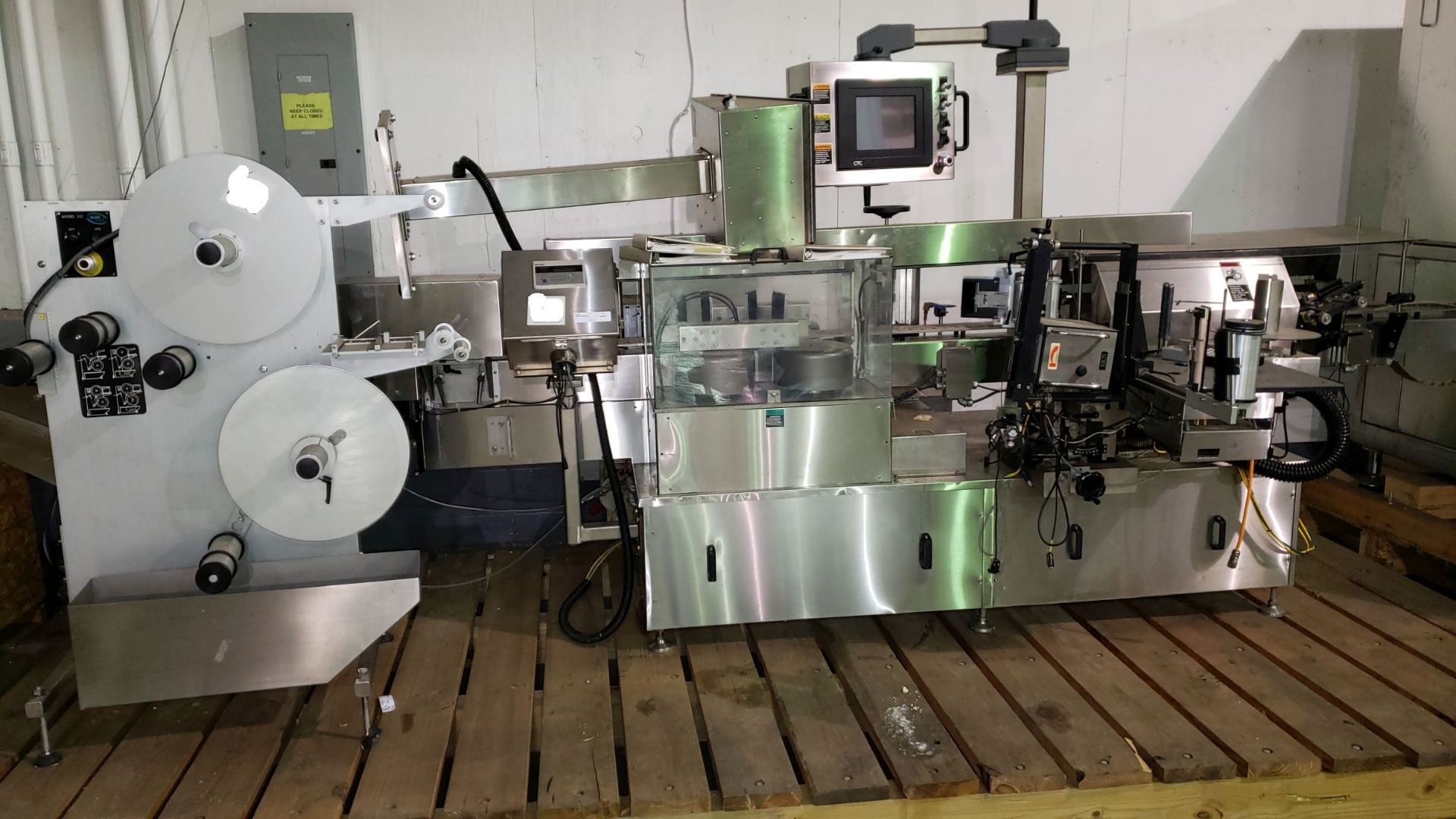 NJM Wrap-Around Labeler, model 334LDBOP245, 230 volt, single phase, with Norwood model Jaguar