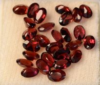 Natural Garnets. Shape Oval Mixed Cut. Approximately 27. Colour Brown. Weight 16.90 Carats.