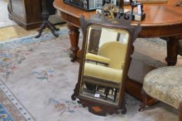 A George III style parcel-gilt mahogany fretwork mirror, with ho-ho bird crest, the bevelled