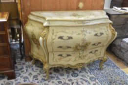 A Venetian style painted and parcel-gilt bombe commode, of serpentine form, fitted with three long