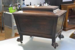 A Regency mahogany sarcophagus cellarette, c. 1820, the stepped top with oval reeded knop, opening