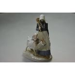 A Royal Copenhagen porcelain group of a girl goatherd, model no. 694. 23cm