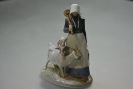 A Royal Copenhagen porcelain group of a girl goatherd, model no. 694. 23cm