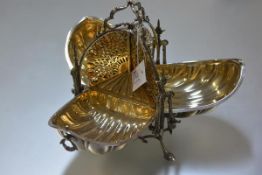 A late 19th century electro-plated triple compartment muffin warmer, modelled as shells, with leaf