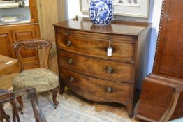 A George III mahogany bowfronted bachelor's chest, the moulded top above a dressing slide and