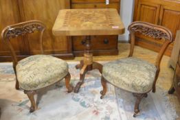 A pair of mid-Victorian walnut nursing chairs, each with shaped scroll and flower-carved back