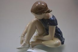 A Royal Copenhagen porcelain figure of a seated young ballerina, model no. 4642. Height 16cm