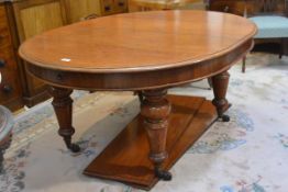 A Victorian mahogany wind-out dining table, the moulded top with bowed ends and two additional