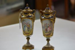 A pair of French gilt-metal mounted porcelain urns and covers, c. 1900, in 18th century style,