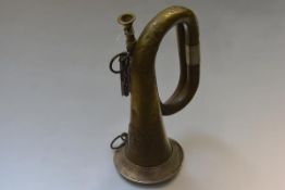 An Imperial German First World War white-metal mounted brass military bugle, with Prussian eagle,